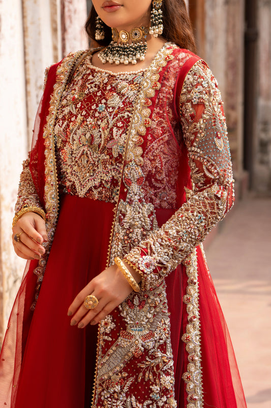 Red and gold embroidered traditional outfit with jewelry