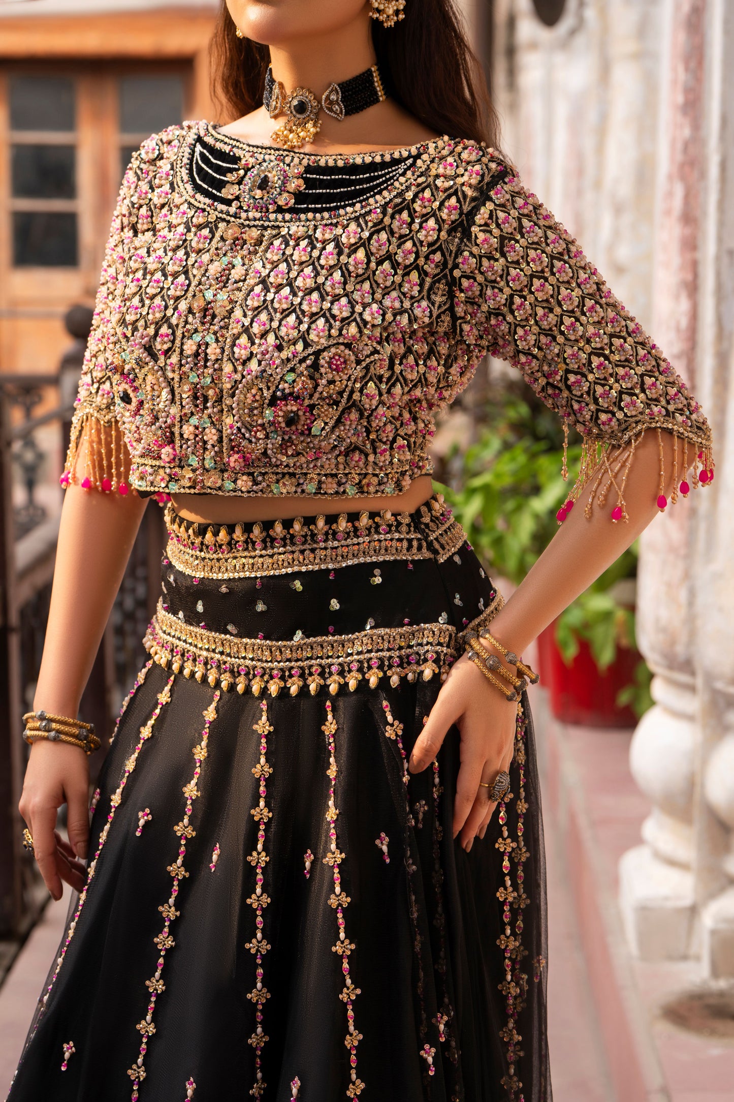 Woman wearing a traditional embroidered outfit with a blurred background