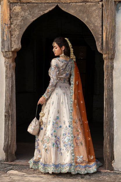 Woman in traditional embroidered dress standing in an archway