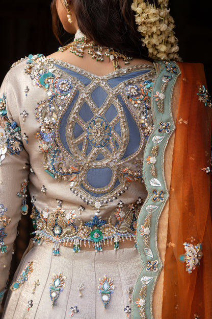 Close-up of a person wearing an intricately embroidered traditional outfit with a focus on the back design.