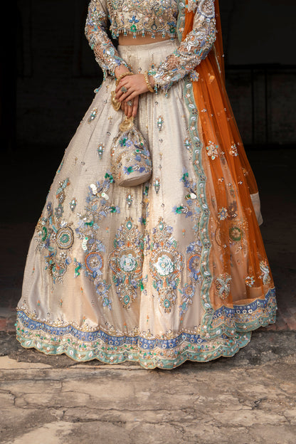 Elegant embroidered traditional outfit with a focus on intricate designs.