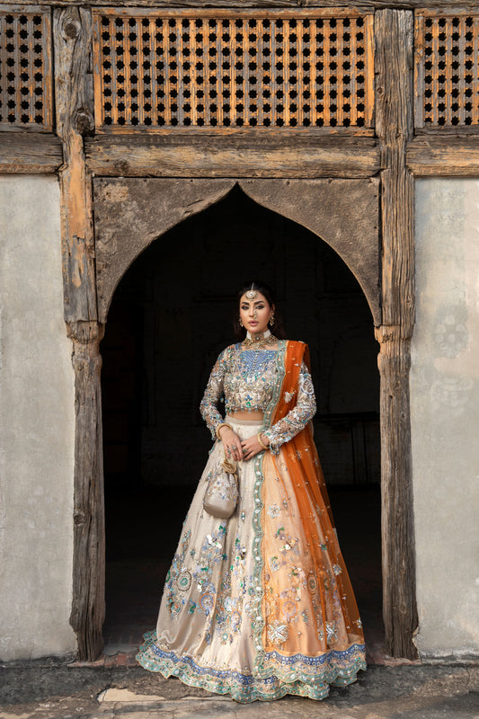 Woman in traditional outfit standing in front of an archway
